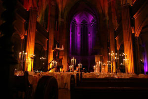 Banquette with candle light dinner and moody lighting, especially the high altar at St. Elisabeth church